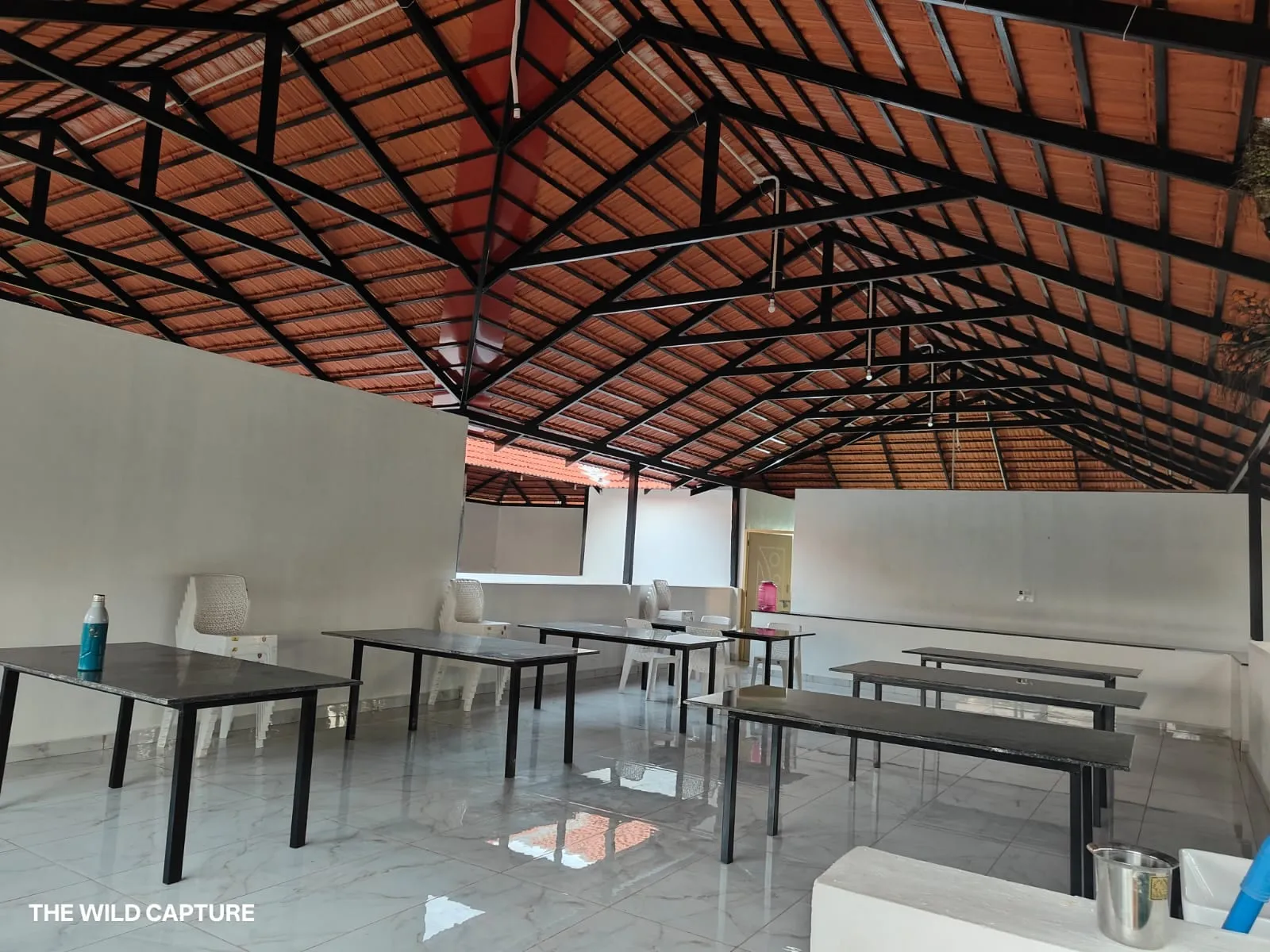 The open dining hall under its terracotta tile roof